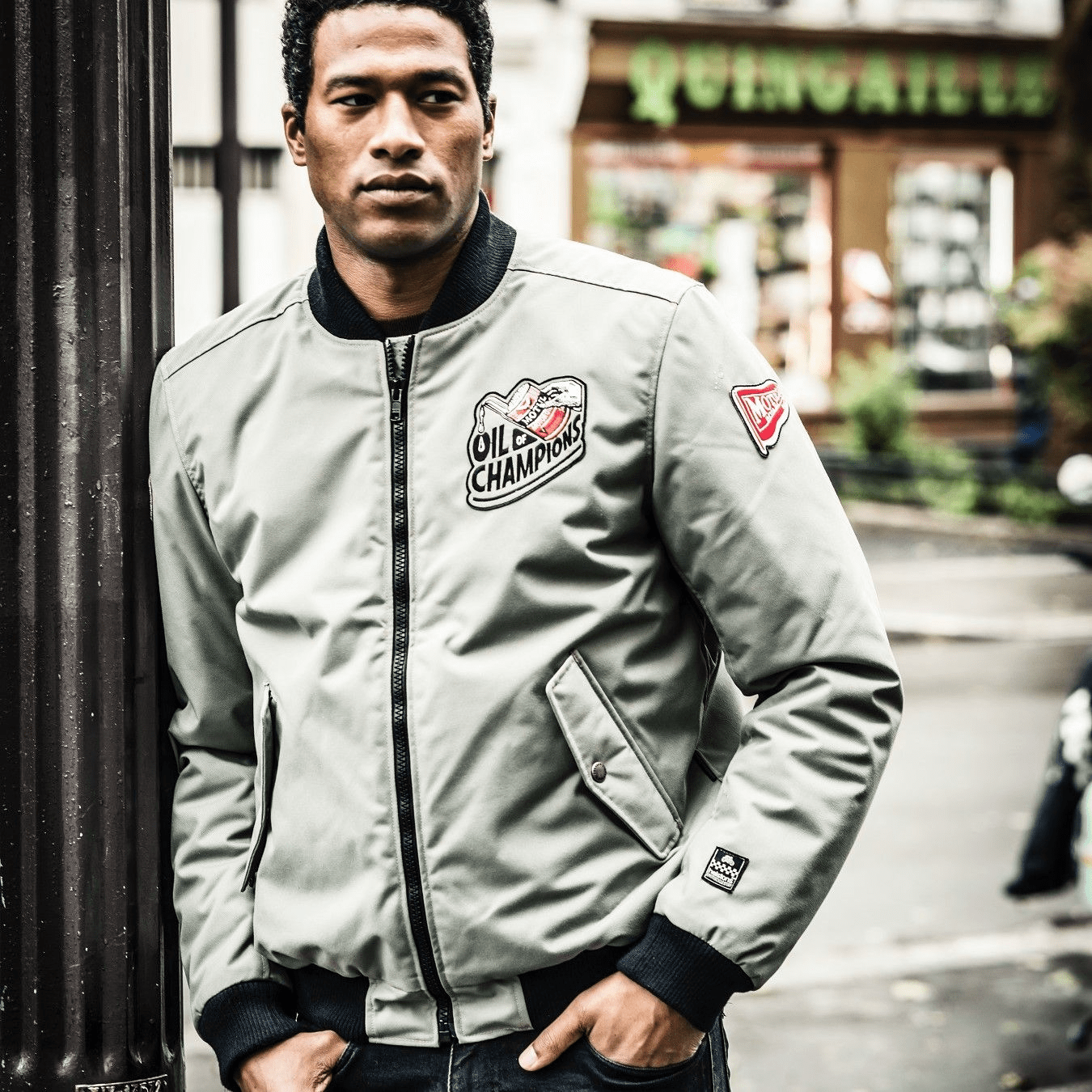 207813 Introducing a modern reimagining of the timeless varsity jacket, this jacket, created in collaboration with the renowned brand of motorcycle oils, Motul, embodies a fusion of technical fabric and soft cowhide inserts, tailored to a slim fit.